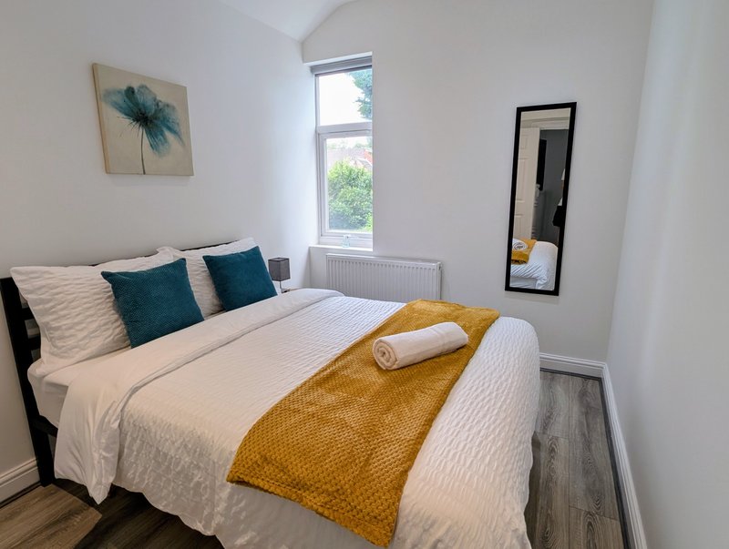 A bright, comfortable double bedroom with a fresh, modern feel. The quality bedding and simple décor provide a relaxing space for contractors to unwind after a long working day.