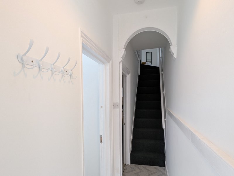 A bright, welcoming entrance with plenty of coat hooks for guests to keep workwear and belongings organised.