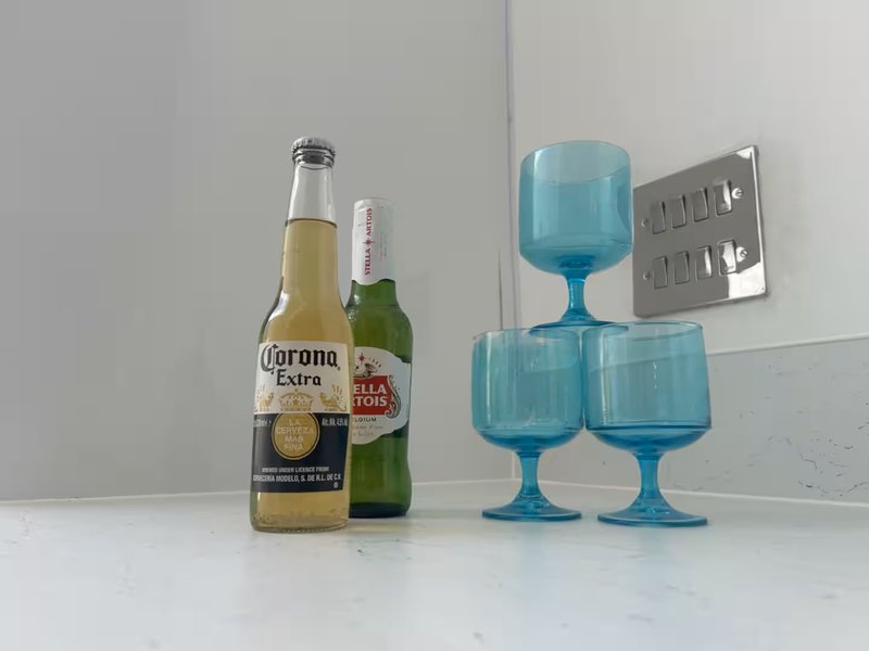 Kitchen counter with beer bottles and blue decorative glassware