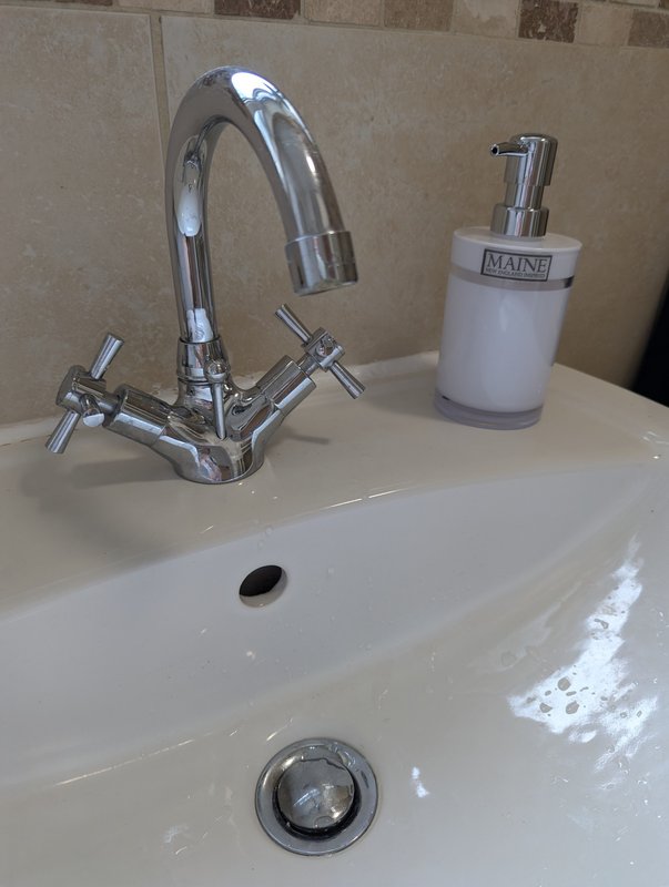 Modern bathroom sink with chrome faucet and soap dispenser