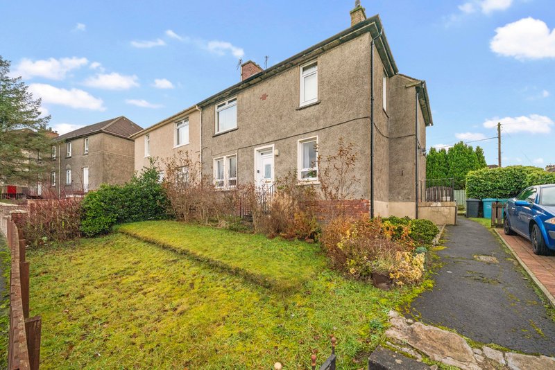 Stone semi-detached house with front garden, driveway and parked car