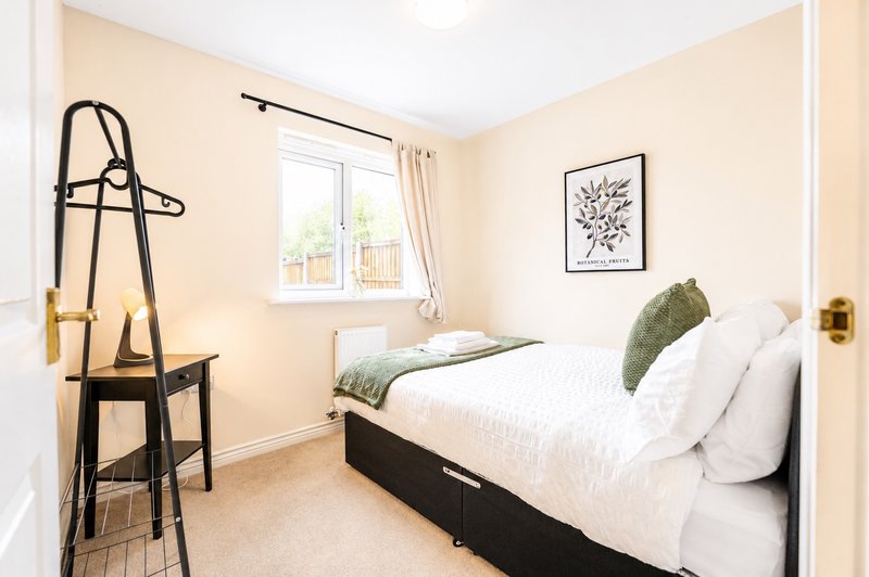 Comfortable and inviting double bedroom featuring a cosy bed with fresh linens, soft furnishings, and natural light. A peaceful space designed for a restful night's sleep.