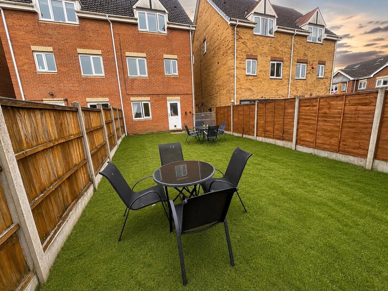 Relax and dine outdoors in our private enclosed garden, featuring two spacious outdoor dining sets perfect for evening meals and drinks. Enjoy peaceful views across open green space.