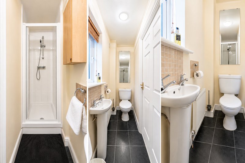 Modern ground-floor shower room featuring a walk-in shower, wash basin, storage cabinet and toilet. Clean, practical, and ideal for larger groups, providing extra convenience and comfort.
