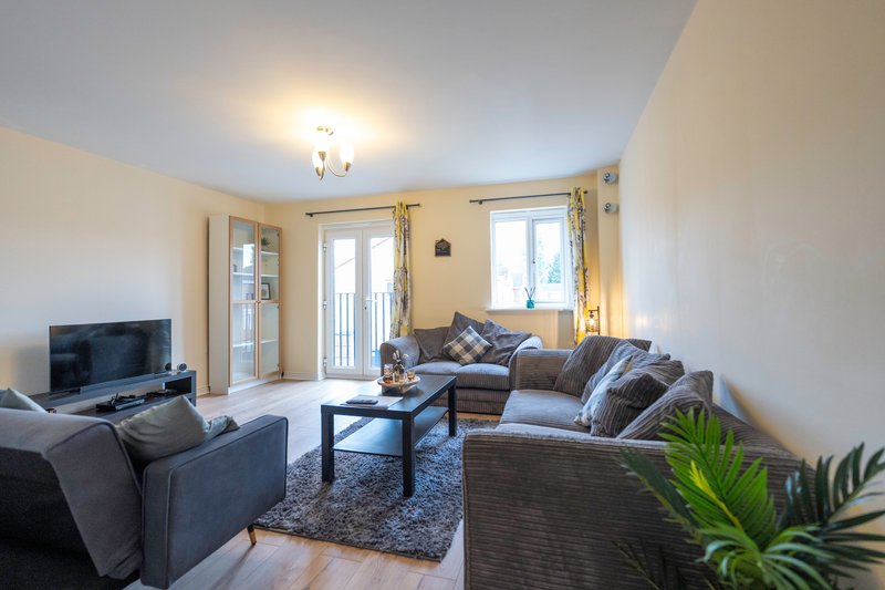 Bright & spacious living room with comfortable seating, Smart TV, and fast Wi-Fi. Large windows & French doors create a light space perfect for relaxing, socialising, or unwinding after a busy day.