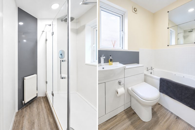 Modern bathroom featuring both a full-size bath & separate walk-in rainfall shower. Bright, spacious & well-maintained with fresh towels provided.
