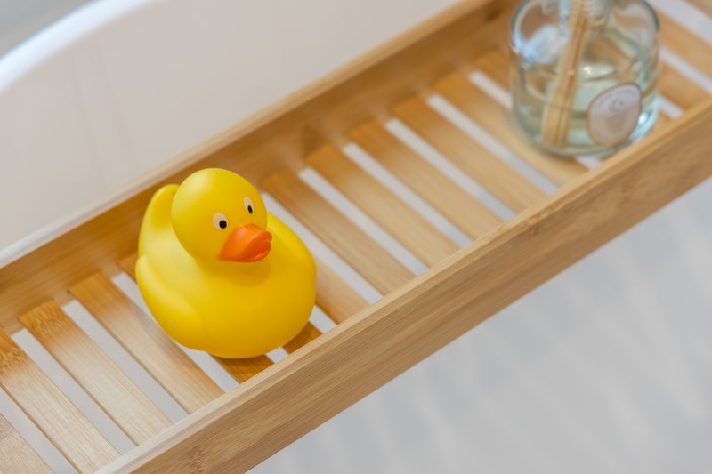 Wooden bathroom shelf with yellow rubber duck and glass jar
