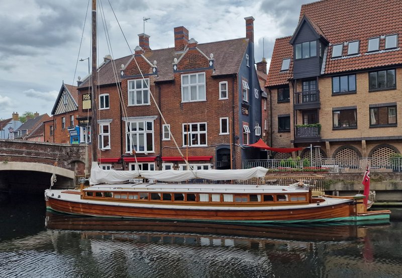 Waterfront townhouses with moored canal boat and brick architecture