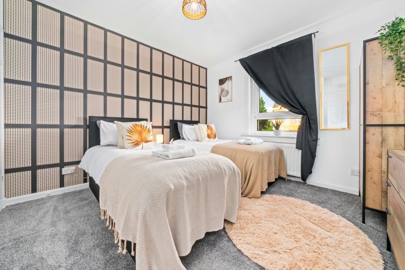Modern bedroom with double bed, geometric wall paneling, black curtain and wooden furniture