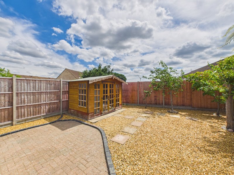 Rear garden with paved patio, gravel area, wooden shed and fencing