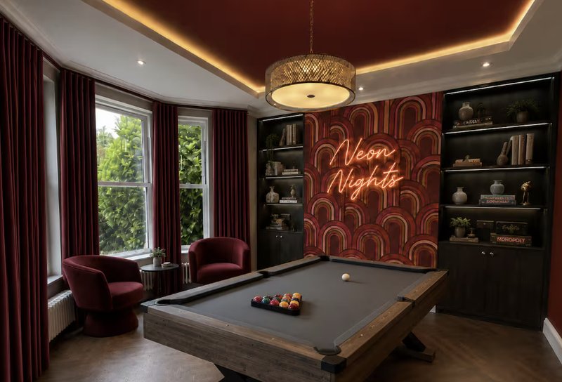 Recreation room with pool table, neon sign, burgundy armchairs, built-in shelving and window seating
