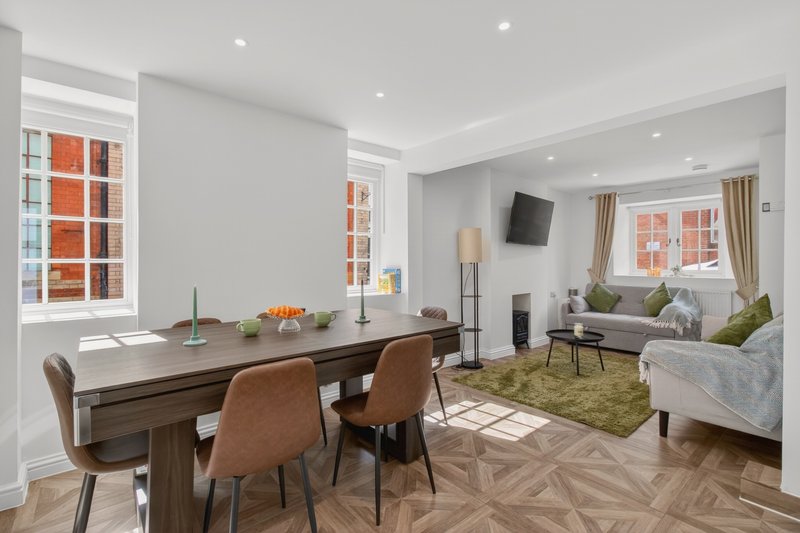 Spacious open-plan living and dining area with comfortable seating, 55-inch Smart TV and pool table – ideal for contractor teams to relax after work. Includes a double sofa bed.