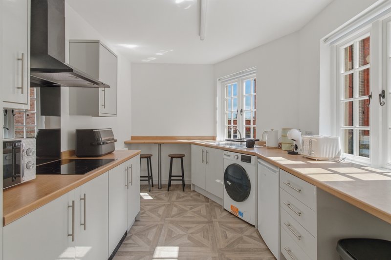 Fully equipped modern kitchen ideal for longer contractor stays, with oven, hob, microwave, washing machine, two fridges plus freezer, kettle, toaster and plenty of storage and worktop space.