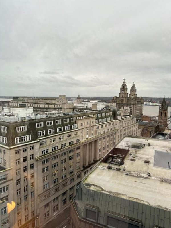 Urban cityscape view from high-rise apartment showing historic buildings and cathedral spires