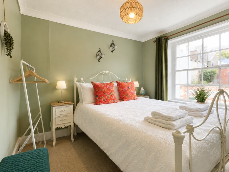 Bedroom 2 - double bed, hanging rail & drawers. Overlooks Tarrant Street which is part of the old town of Arundel giving a glimpse of the historic castle as well.