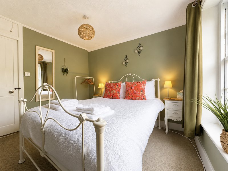 Bedroom 2 with double bed, bedside drawers and hanging rail