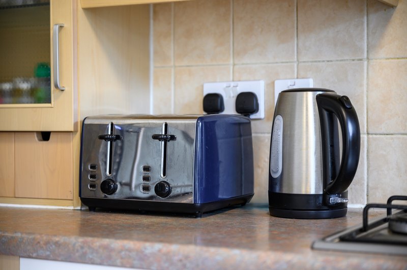 Kitchen counter with toaster, kettle, and small appliances