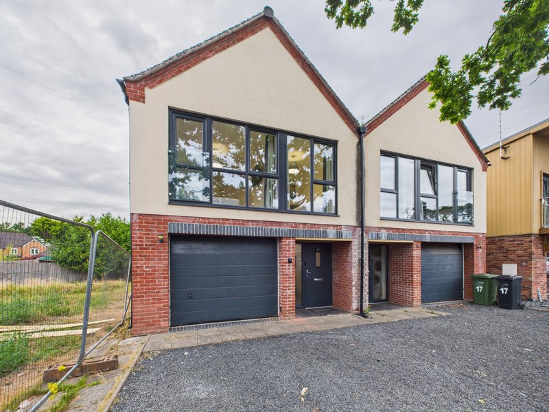 Modern brick and render house with double garage, driveway and front garden fencing