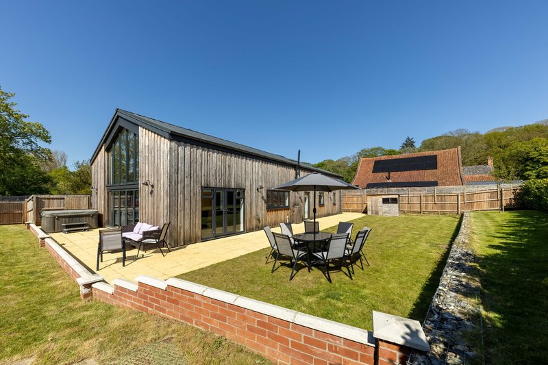Modern rural property with decking, garden furniture and brick boundary wall