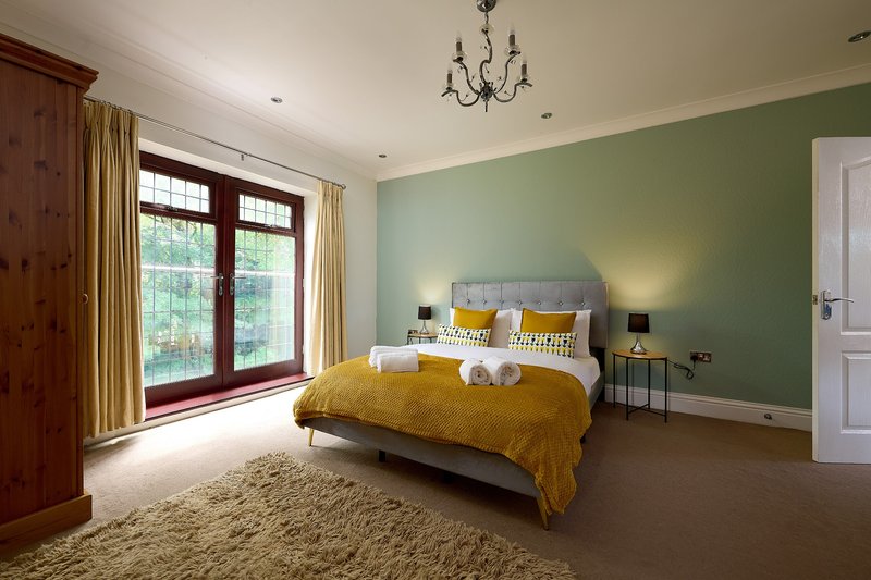 A bright and comfortable double bedroom with a generous layout, quality bedding and plenty of storage. The large windows bring in plenty of natural light, creating a welcoming space to unwind.