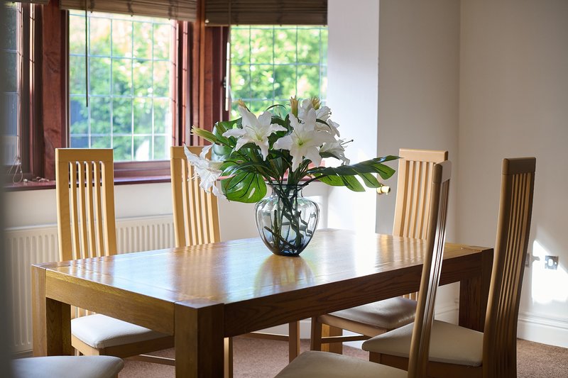 A spacious dining area within the main living space, providing a comfortable setting for the group to eat together.