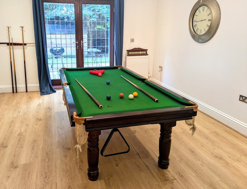 Featuring a full-size pool table, with cues and balls provided for guests to enjoy. The generous space around the table allows for comfortable play and makes this area a great space for entertaining