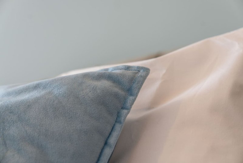 Close-up of decorative cushions in blue and cream on upholstered furniture