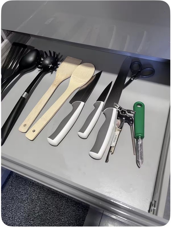 Kitchen drawer organizer with cooking utensils, knives, and kitchen tools neatly arranged