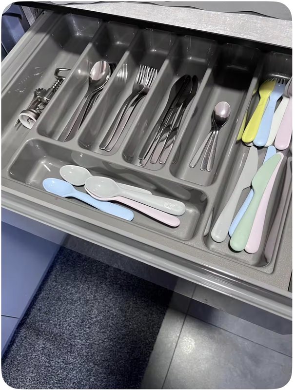 Kitchen drawer organizer with cutlery, utensils and kitchen tools neatly arranged