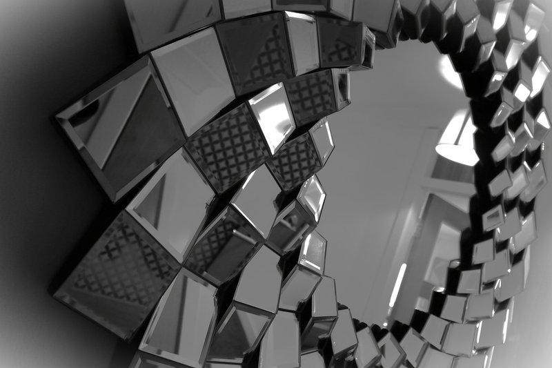 Black and white overhead view of modern office chairs arranged in circular pattern
