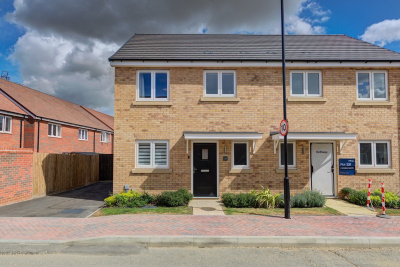 Modern brick semi-detached house with driveway, front garden and street frontage