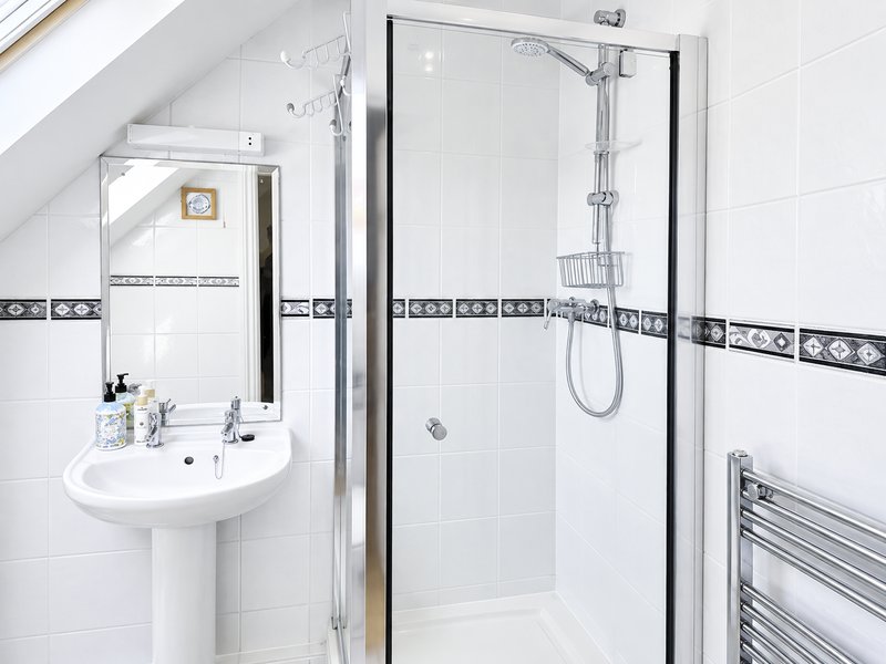 Shower room en-suite to Bedroom 2. Bath and hand towels provides for guests along with complimentary toiletries: shampoo, conditioners, hand wash and shower gel
