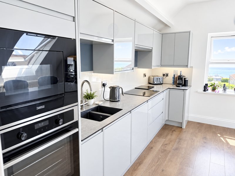 Modern kitchen with oven, hob, dishwasher, fridge/freezer, microwave, coffee machine, kettle and toaster