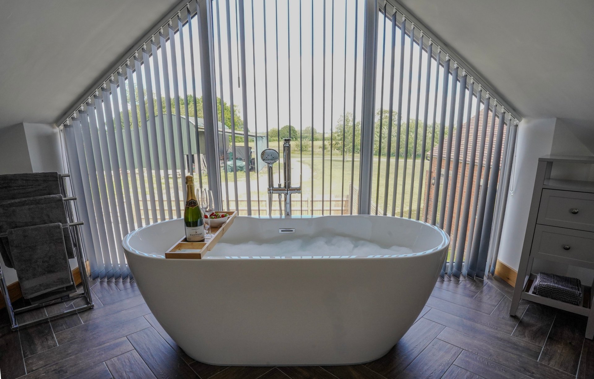 After a busy day on site, unwind in the property’s luxurious freestanding bath, positioned in a bright, spacious bathroom with beautiful views across the surrounding countryside.