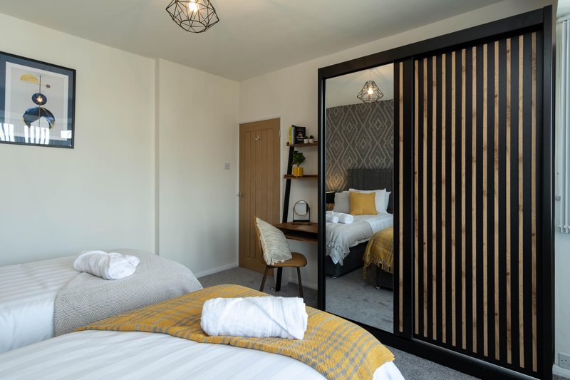 1 double bed and 1 single bed. Wardrobe and desk area