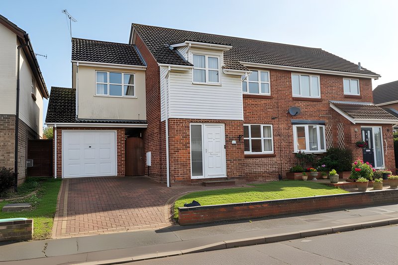 Brick semi-detached house with driveway, garage, and front garden landscaping