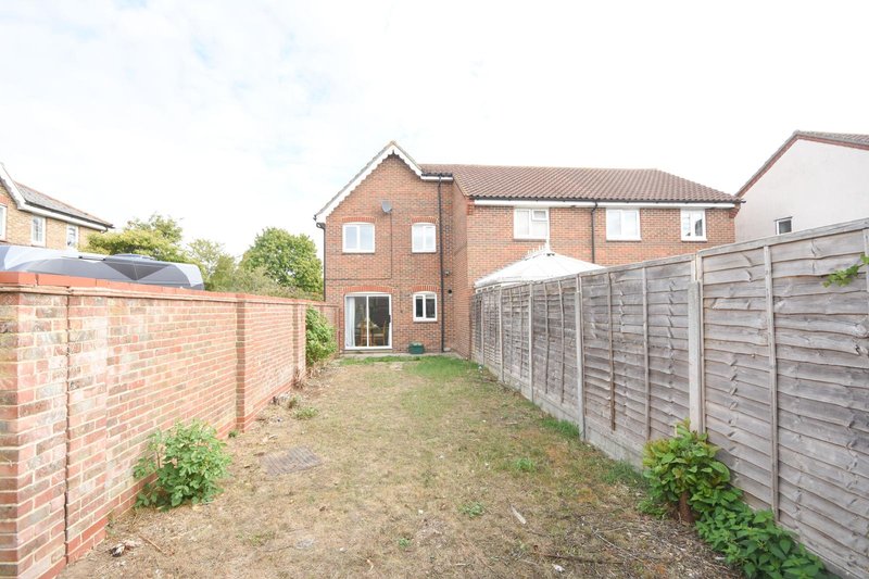 Brick detached house with garden, fencing and neighboring properties visible