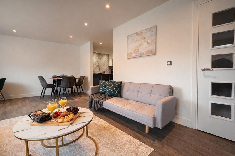 Open-plan living area with sofa, dining table, dedicated workstation and modern furnishings