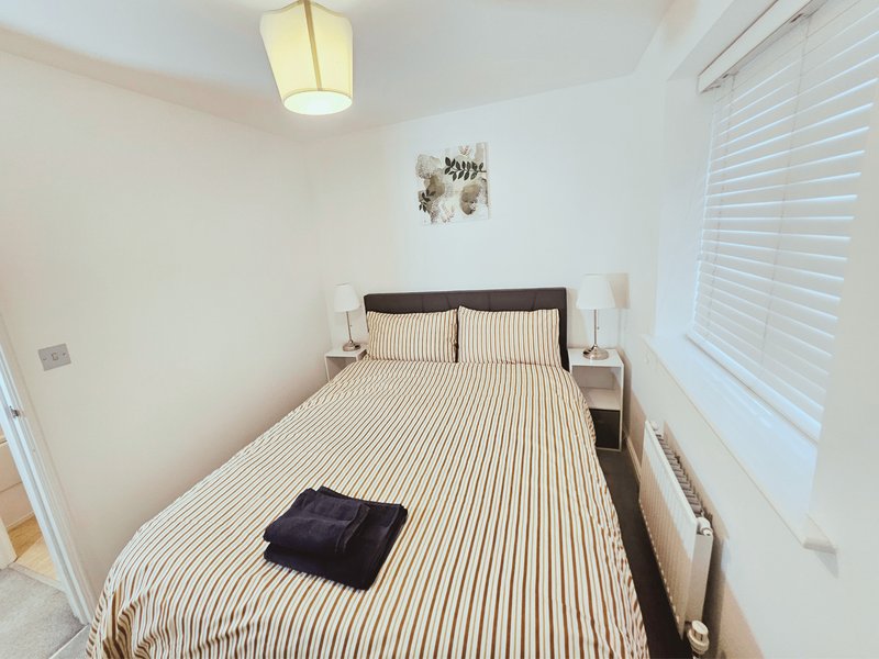 Second Bedroom (King bed) -Bright bedroom with double bed, striped bedding, wooden headboard and bedside tables