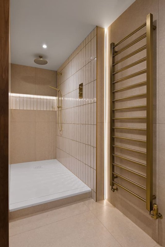 Modern bathroom with walk-in shower, heated towel rail, and recessed lighting