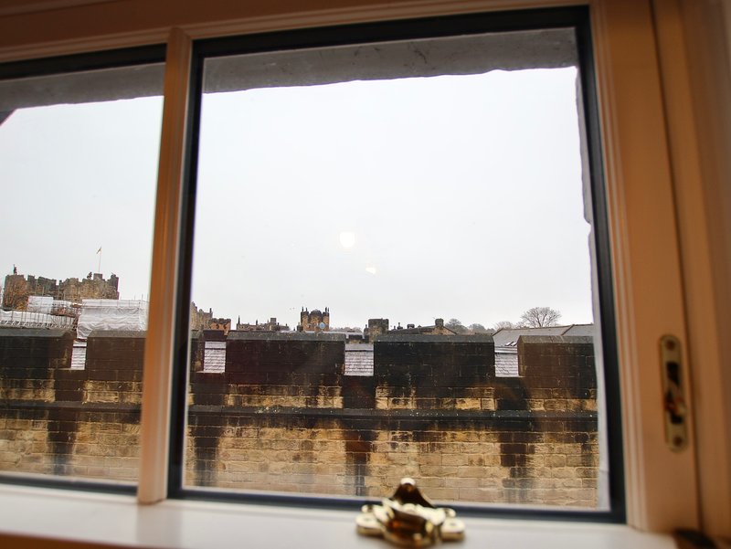 View through window of riverside buildings and historic architecture across water