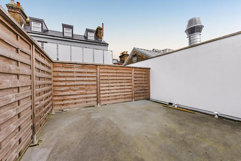 Rooftop terrace with wooden fencing, concrete flooring and city views