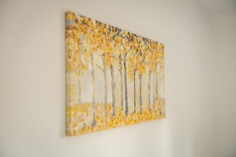 Abstract wall art with yellow and white tones depicting trees in mist