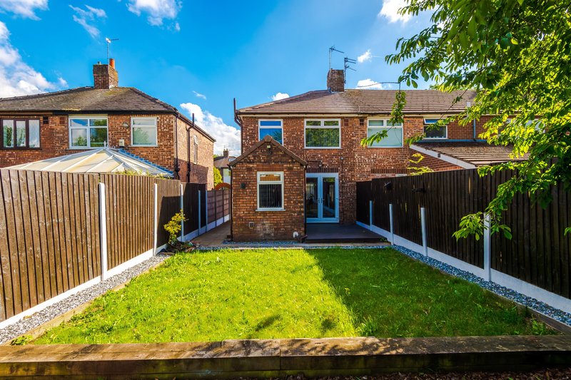 Brick semi-detached house with garden, fence, and patio area
