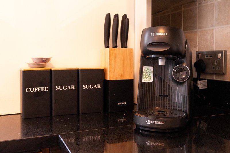 Kitchen counter with coffee and sugar containers, knife block, and Bosch coffee machine