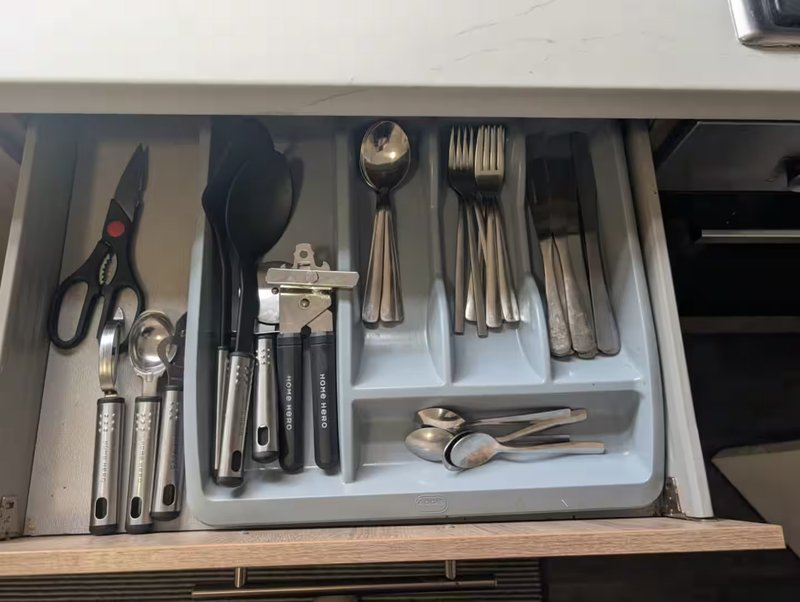 Kitchen drawer organizer with cutlery, utensils, and cooking tools neatly arranged