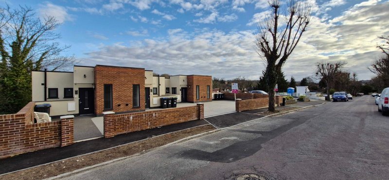 Modern brick residential property with driveway, front garden, and street view