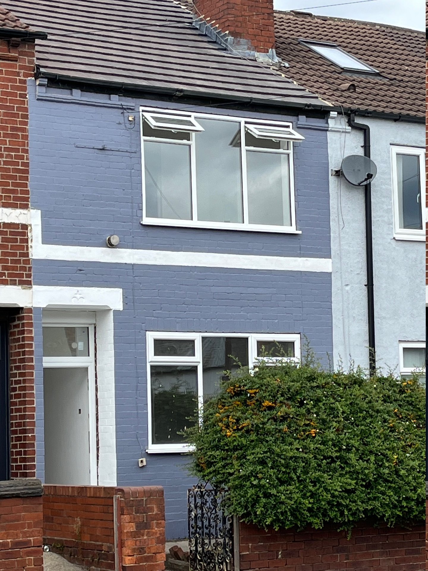 Grey and white terraced property with buffer garden