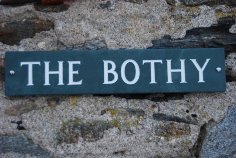 Blue nameplate reading 'THE BOTHY' mounted on stone wall exterior