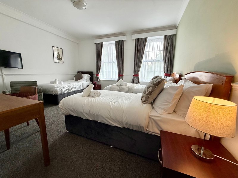 Relax in our spacious Triple Room, ideal for up to three guests. It offers three single beds, a private bathroom, Smart TV, fast Wi-Fi and tea and coffee facilities. Room layouts and décor may vary.